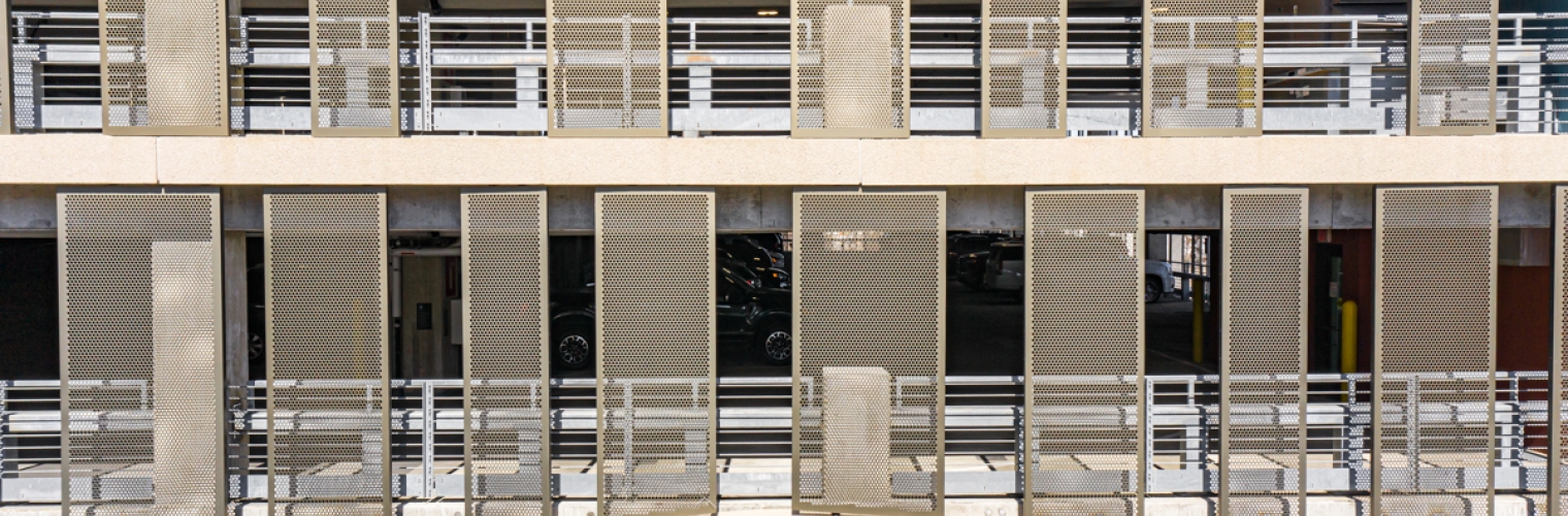 close up of perforated metal on a parking garage