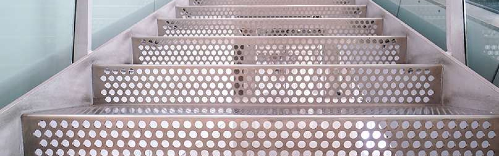 a close up of perforated metal stair treads and risers