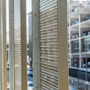 Looking at perforated metal from a parking Garage